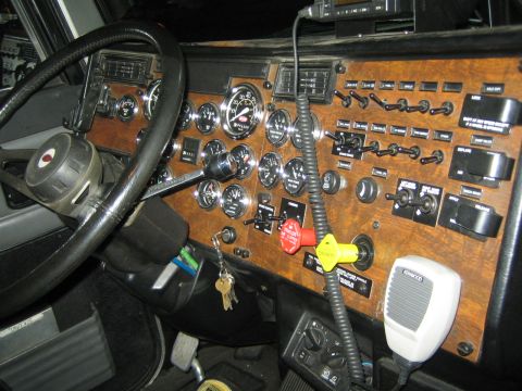 1968 Ford Mustang - The interior of a truck features a complex dashboard with many gauges and switches, along with a CB radio microphone.