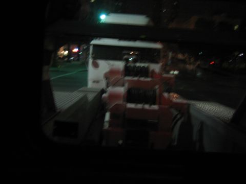 1968 Ford Mustang - A tow truck is parked at night, its winch mechanism clearly visible.