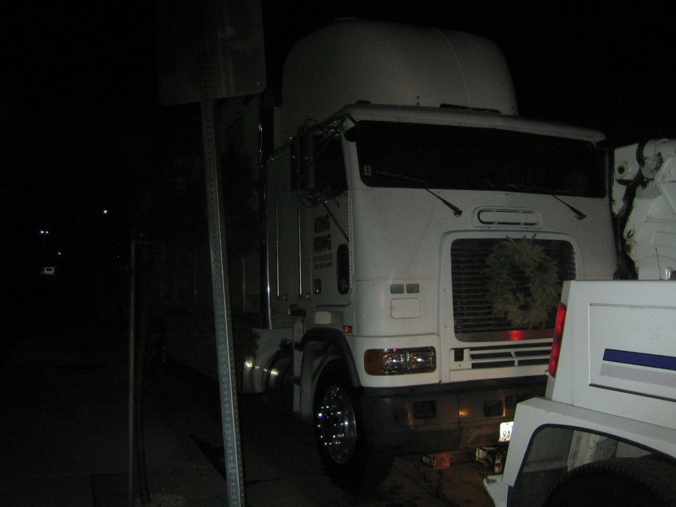 White semi-truck with a wreath on the grille, parked at night. Text on the door reads 'KING KONG'