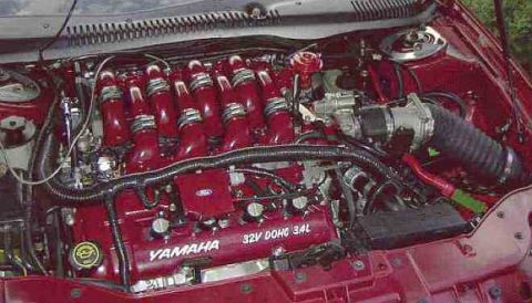 1997 Ford Taurus - Close-up of an engine bay, highlighting a red intake manifold with Yamaha branding and "32V DOHC 3.4L" markings.
