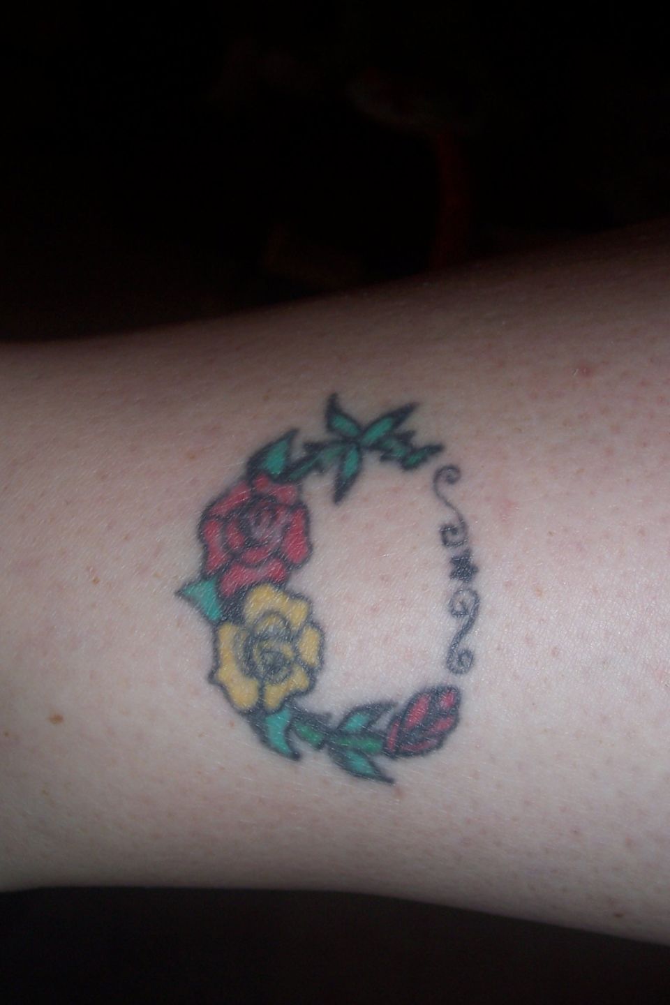 Tattoo of roses and vines forming a circle
