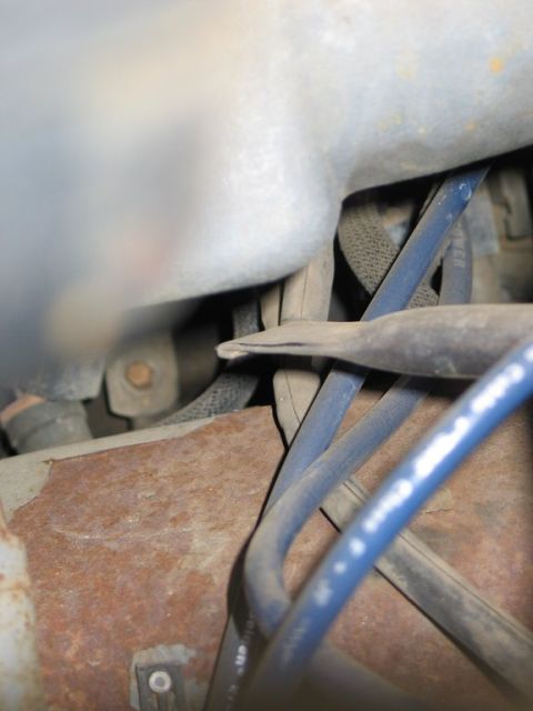 1989 Ford F-150 - A view into the engine compartment, showing various wires and components with signs of rust.