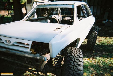 1991 Ford Bronco - This 1991 Ford Bronco is heavily modified with off-road suspension and tires, its body is primed white.