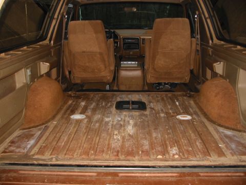 1988 Ford Bronco - The interior of a van or SUV shows the cargo area and the front seats, with a dashboard visible in the background.