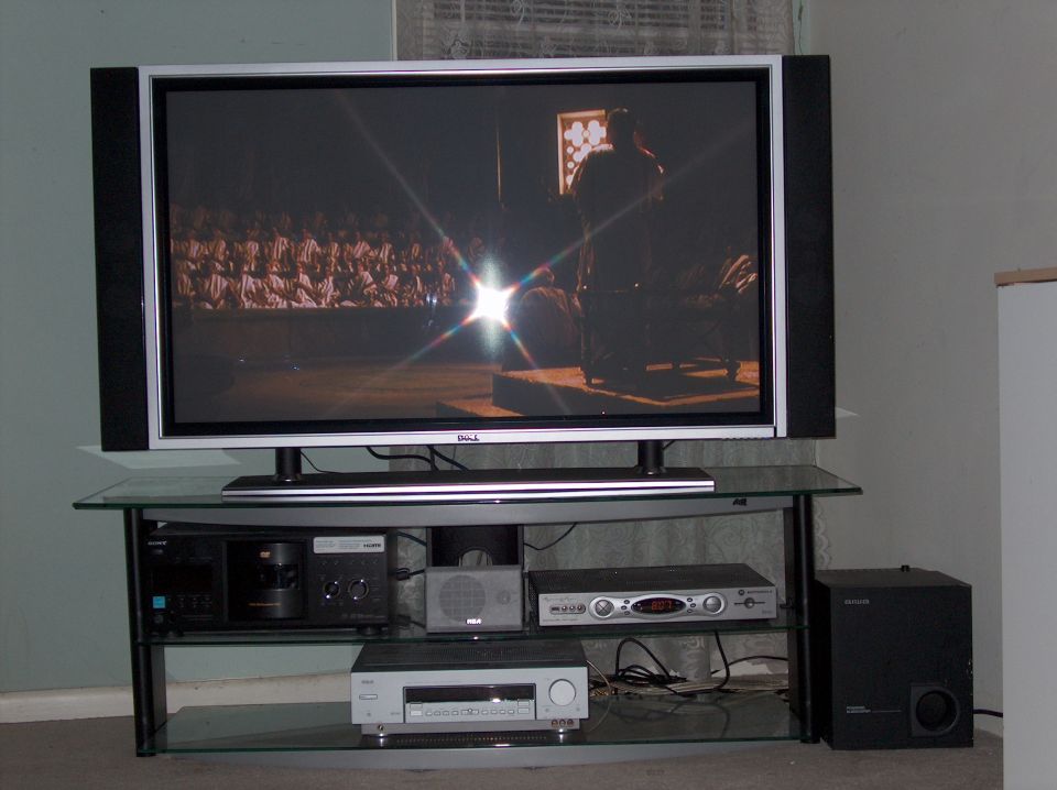 Living room home theater setup with flat-panel TV, receiver components and subwoofer