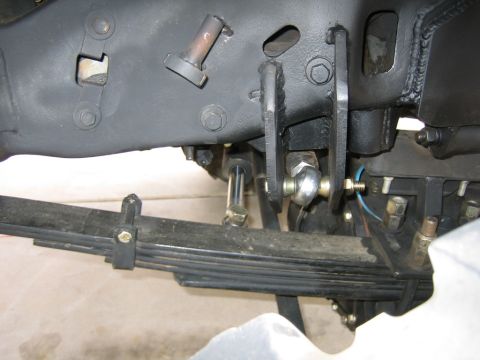 1994 Ford Bronco - Underside view of a vehicle's suspension system, focusing on the leaf spring and linkage.