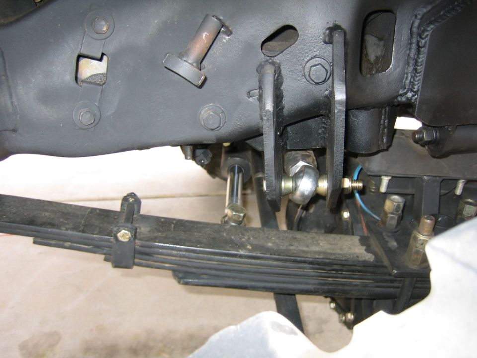 Close-up of a vehicle's leaf spring and suspension linkage