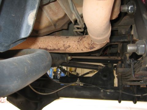 1994 Ford Bronco - Underside view of exhaust pipes and suspension components, with 'SUPERMOTORS.NET' visible at the bottom.