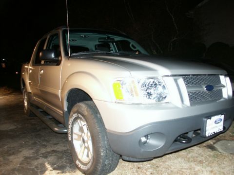 2001 Mercury Grand Marquis - This Ford Explorer Sport Trac is a compact pickup truck with a silver exterior, seen parked at night.