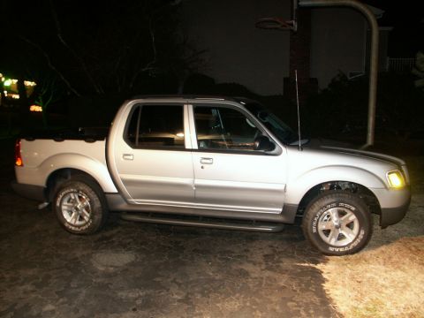 2001 Mercury Grand Marquis - Side view of a silver 2001 Ford Explorer Sport Trac pickup truck, with Goodyear Wrangler tires visible.