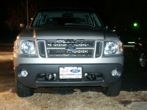 2001 Mercury Grand Marquis - Front view of a 2001 Ford Explorer Sport Trac, showing its grille and headlights at night.