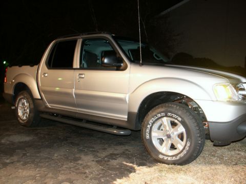 2001 Mercury Grand Marquis - This silver Ford Explorer Sport Trac pickup truck is shown from the front three-quarter angle at night.