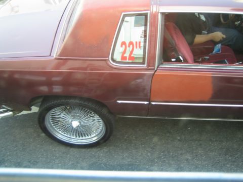 1968 Ford Mustang - A side view of a maroon coupe with custom wire wheels and a "22" decal on the window.