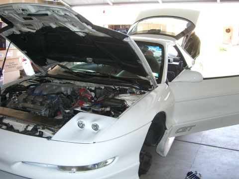 1996 Ford Probe - White 1996 Ford Probe GT with hood and doors open, revealing the engine bay.
