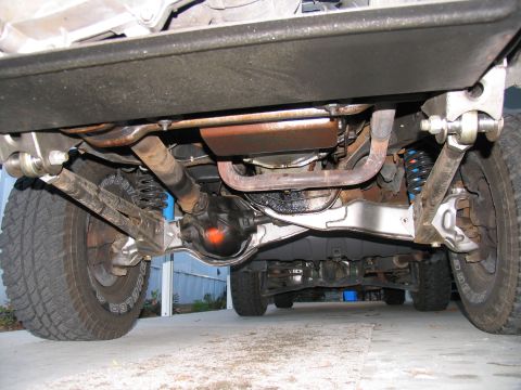 1984 Ford Bronco - A detailed look at the undercarriage of a 4x4 vehicle, highlighting its suspension and drivetrain.