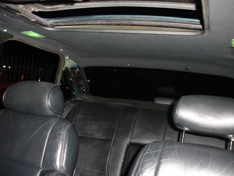 1993 Ford Taurus - Interior view of a car's rear seats and headliner, showing black leather upholstery and a sunroof.