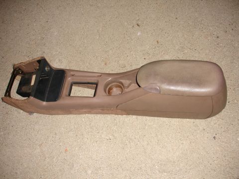 1993 Ford Taurus - Center console assembly from a vehicle, a brown armrest and integrated cupholder.