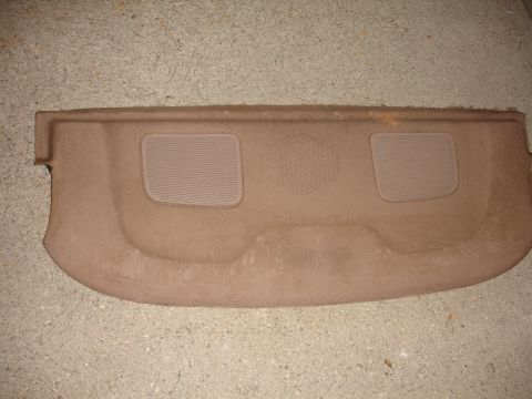1993 Ford Taurus - This is a car's rear deck shelf, likely for speakers, lying on a concrete surface.