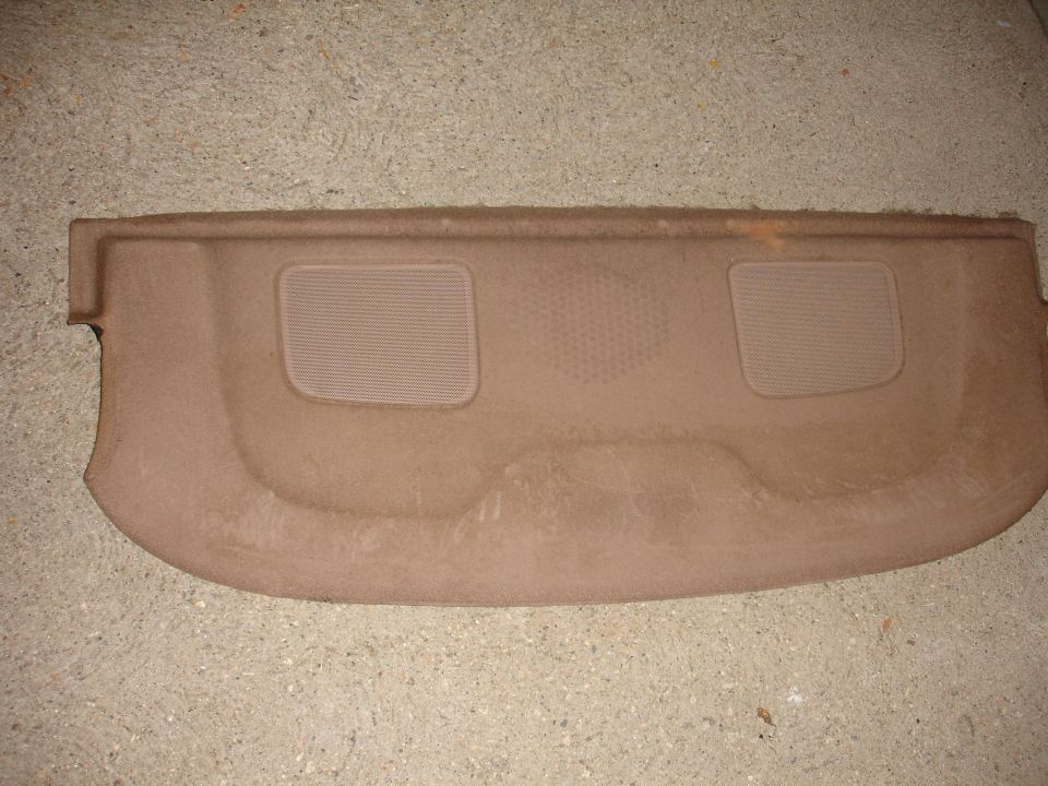 Tan car rear deck shelf with two speaker cutouts