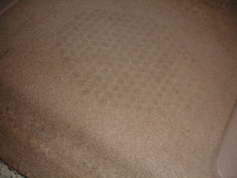 1993 Ford Taurus - Close-up view of worn tan car seat upholstery.