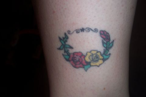 1987 Ford Bronco - A close-up photo shows a colorful tattoo of a floral wreath on skin.