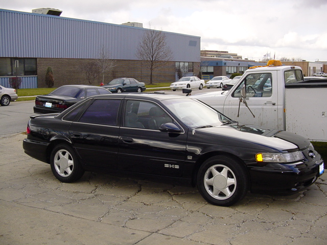 Black 1998 Ford Taurus sedan, 3/4 front view