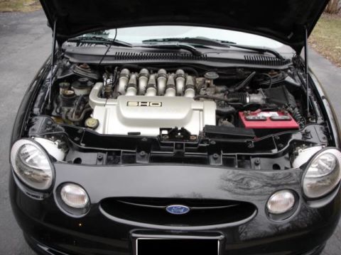 1998 Ford Taurus - The engine bay of a 1998 Ford Taurus SHO, its V8 engine and black exterior.