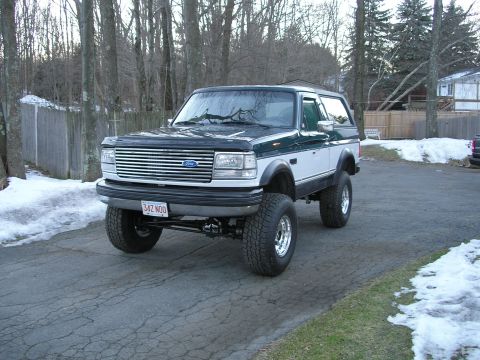1994 Ford Bronco - This lifted Ford Bronco features a distinctive two-tone paint scheme and prominent aftermarket wheels.