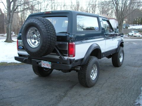 1994 Ford Bronco - This Ford Bronco features a two-tone paint scheme and a rear-mounted spare tire.