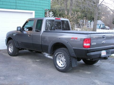 1994 Ford Bronco - Gray Ford Ranger pickup truck with black trim and fender flares parked in a driveway.