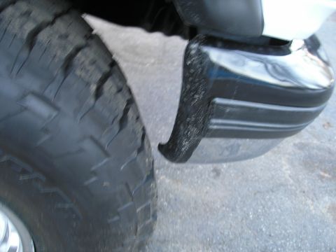 1994 Ford Bronco - Detail shot of a vehicle's tire and bumper corner.