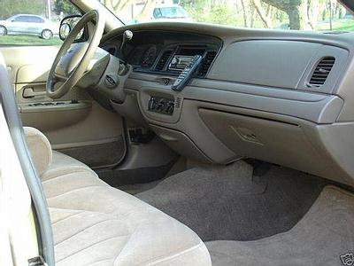 1999 Ford Crown Victoria - Interior view of a 1999 Ford Crown Victoria, highlighting the dashboard and seating.