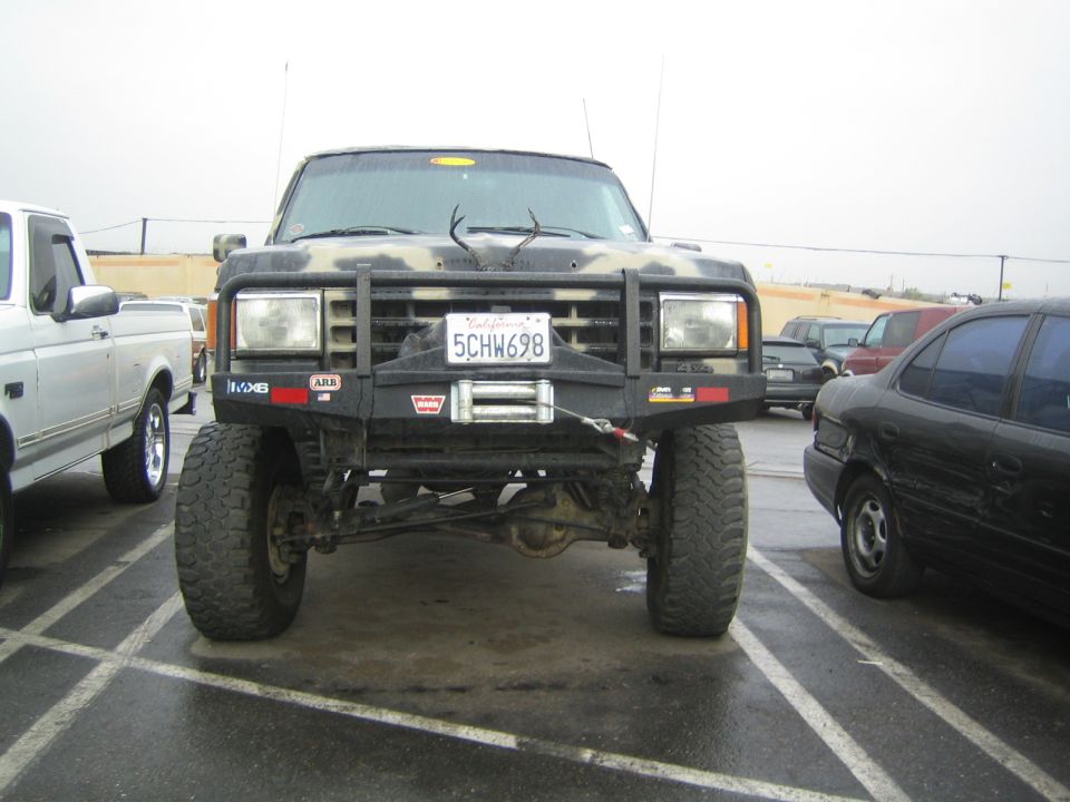 Front of a lifted camo truck with brush guard and Warn winch, California plate 5CHW698