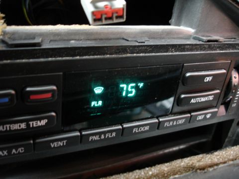 1993 Ford Taurus - Climate control panel with digital display showing 75 degrees Fahrenheit and mode selection buttons.