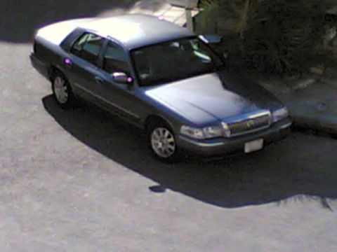 1999 Mercury Grand Marquis - This 1999 Mercury Grand Marquis sedan is captured from a high angle, showing its front three-quarter view.