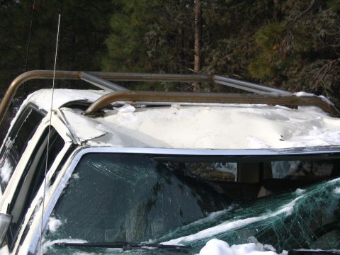 1988 Ford Bronco - This 1988 Ford Bronco shows significant damage to its roof and windshield after an apparent rollover incident.