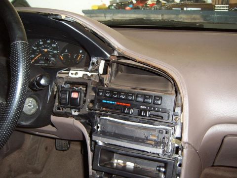 1993 Mazda MX-6 - Dashboard disassembly in a 1993 Mazda MX-6, exposing the radio and climate control systems.
