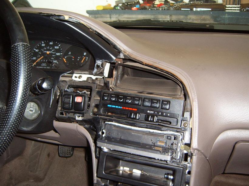 1993 Mazda MX-6 interior with dashboard disassembled, showing radio and climate controls removed