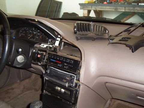1993 Mazda MX-6 - Disassembled dashboard of a 1993 Mazda MX-6, revealing the radio and climate control systems.