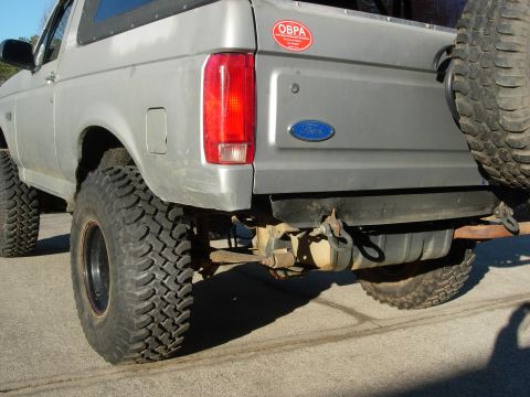 1995 Ford Bronco - Rear view of a 1995 Ford Bronco showing the tailgate, taillight, and spare tire.