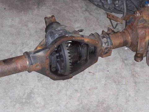 1991 Ford Bronco - Close-up view of a vehicle's differential housing, showing internal gears and rusty axle components.