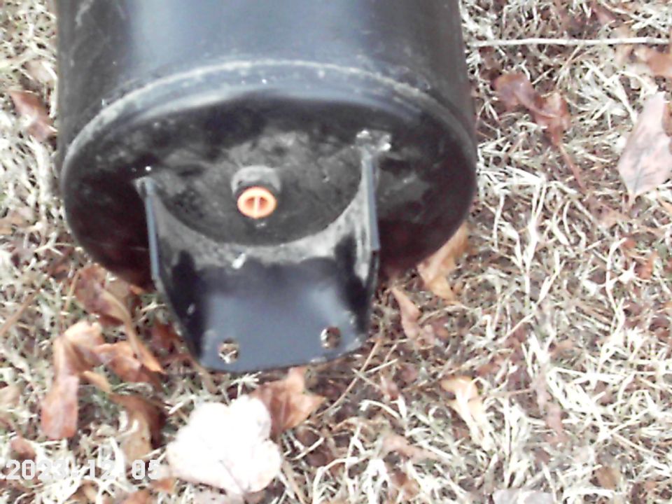 Black cylindrical tank with metal bracket and orange fitting