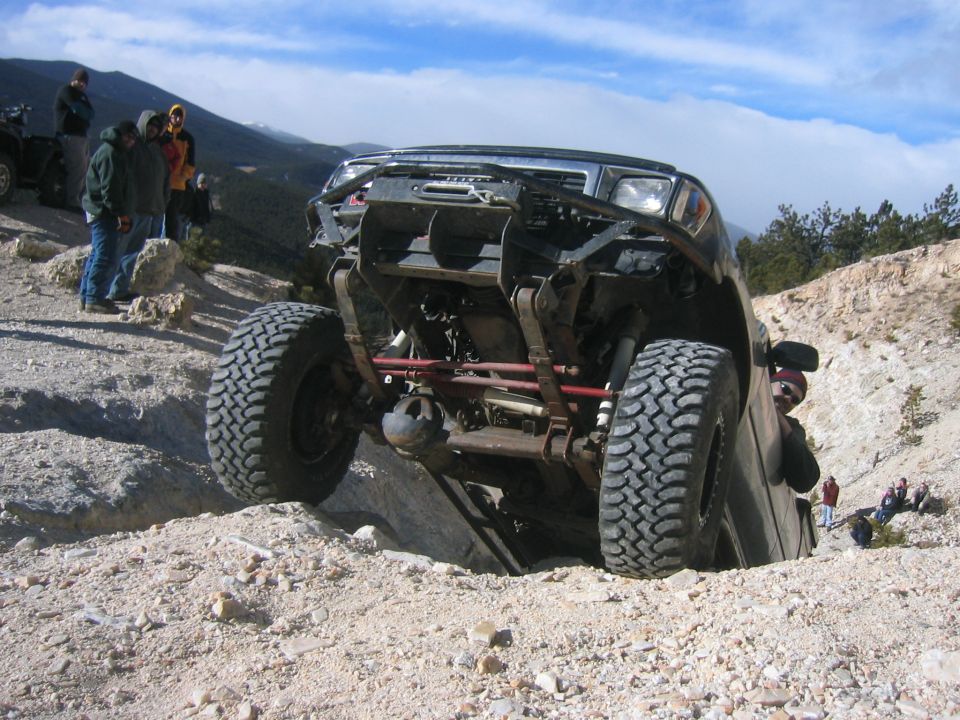 Off-road vehicle with lifted suspension navigating rough terrain