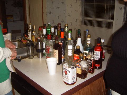 1988 Ford Bronco - A large selection of alcoholic beverages are displayed on a countertop, ready for a gathering.