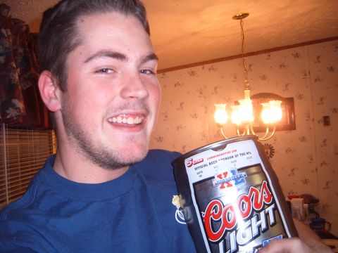 1988 Ford Bronco - Man holds a large Coors Light beer can, which is an official NFL sponsor.