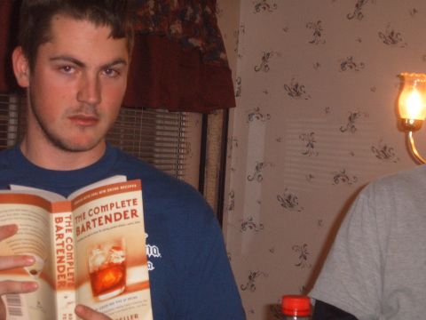 1988 Ford Bronco - A man holds a book about bartending, with a drink recipe visible on the open page.