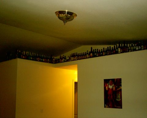 1996 Ford Probe - An interior view shows a shelf lined with numerous bottles above a wall adorned with a poster and a SuperMotors watermark.