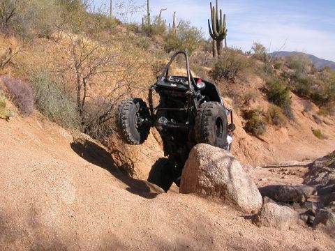 1984 Ford Bronco - This off-road buggy is navigating a difficult rocky terrain in a desert environment.