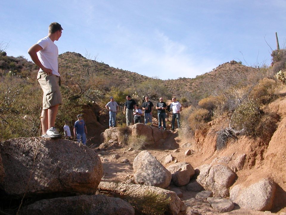 Group of people on rocks in a desert canyon