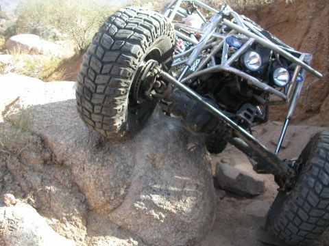 1984 Ford Bronco - Custom off-road buggy navigating difficult terrain on a rocky trail.